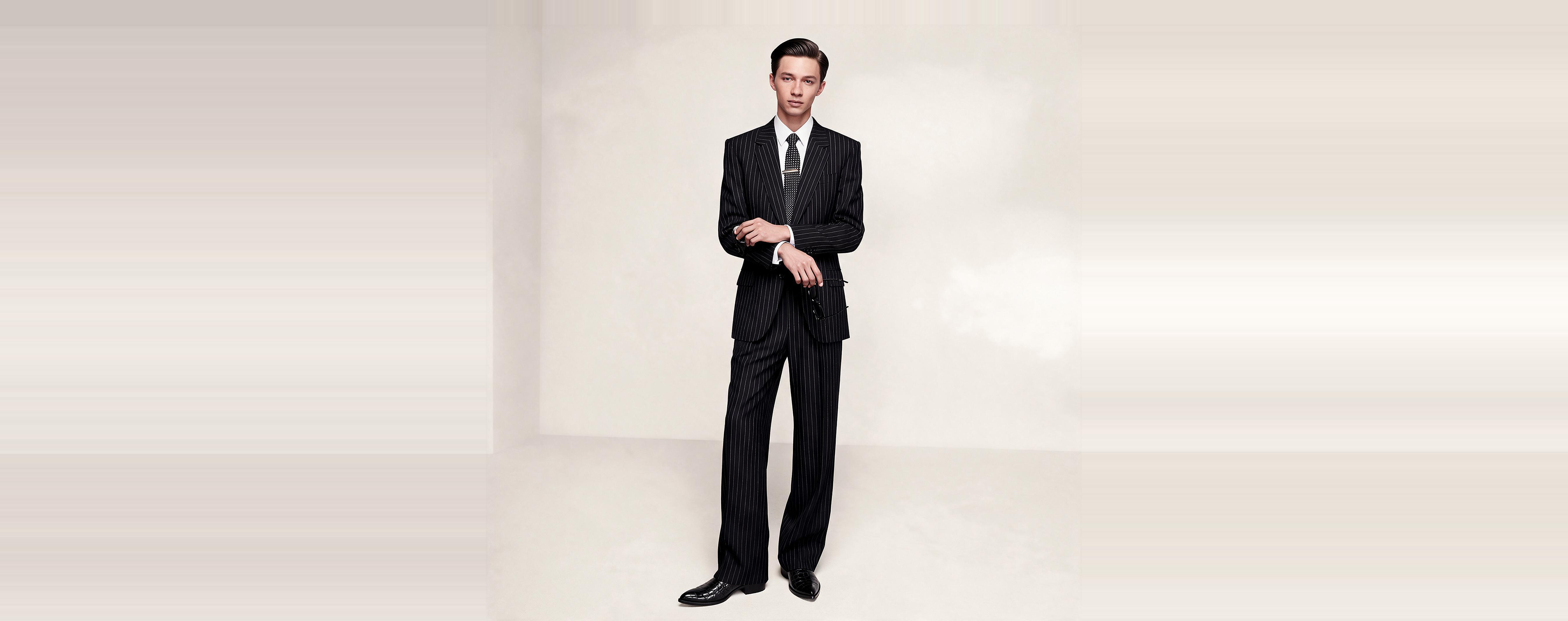 A model in a navy pinstripe suit